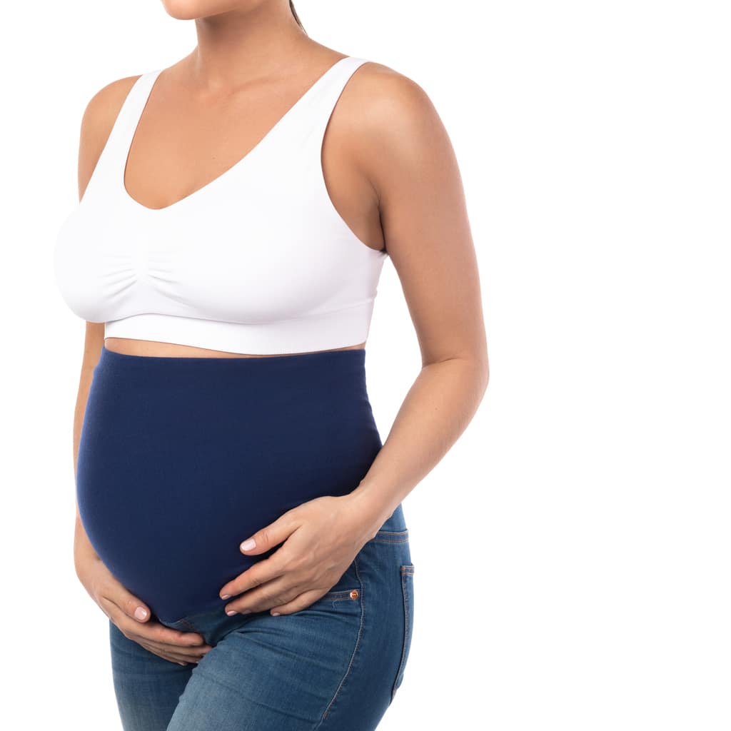 Young pregnant woman wearing maternity jeans isolated on white background